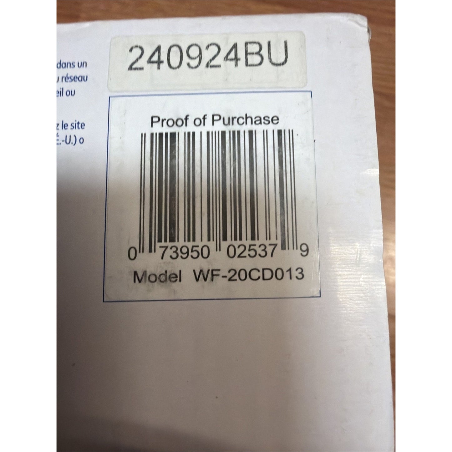 Close-up of a white product box corner featuring a barcode with the label "Proof of Purchase," model number WF-20CD013, and a separate alphanumeric sticker reading 240924BU.