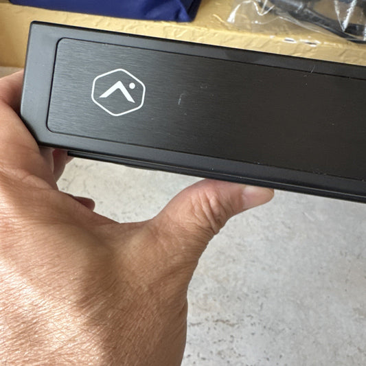 Alarm.com 8 channel commercial streaming video recorder showing front panel with Alarm.com logo and hand holding device