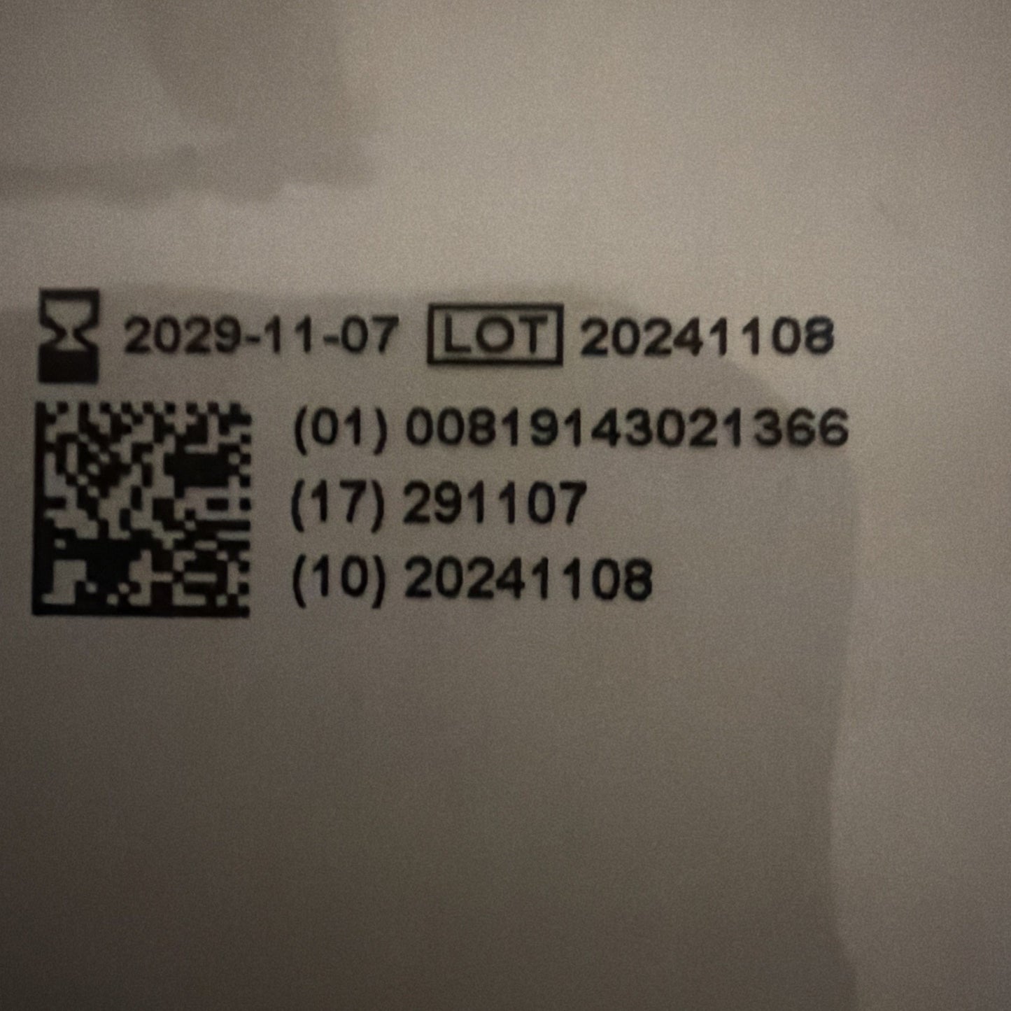 Black printed expiration date "2029-11-07," lot number "20241108," and product codes alongside a QR code on a white background.