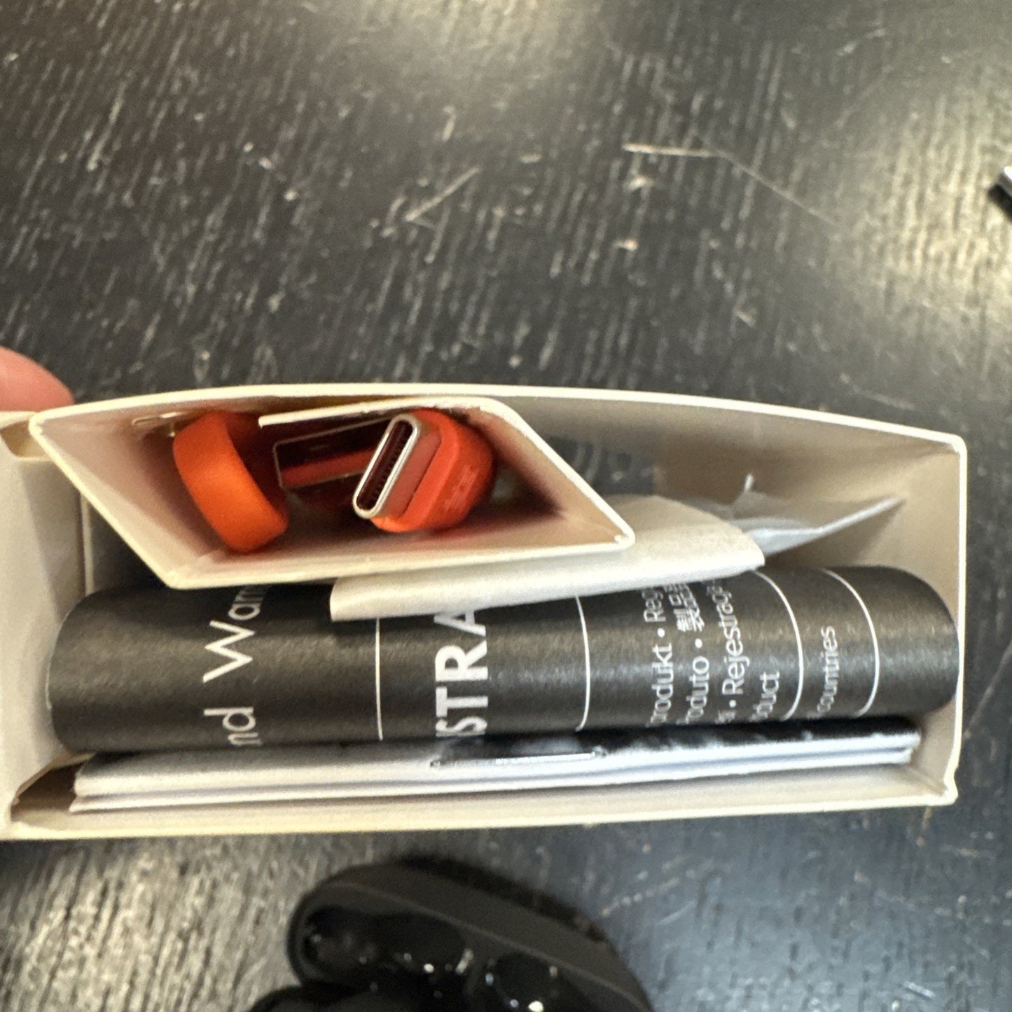 Top view of JBL Vibe Beam True Wireless Bluetooth Earbuds box contents including USB charging cable and product manuals in white packaging