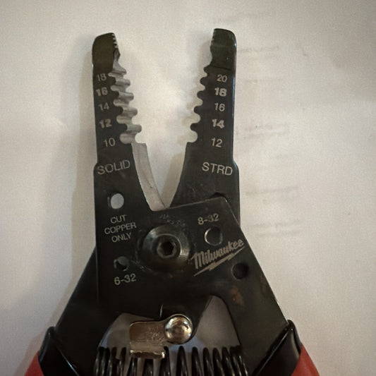 Milwaukee Automatic Wire Stripper showing jaws with wire gauge sizes 10 to 20 AWG and solid and stranded markings