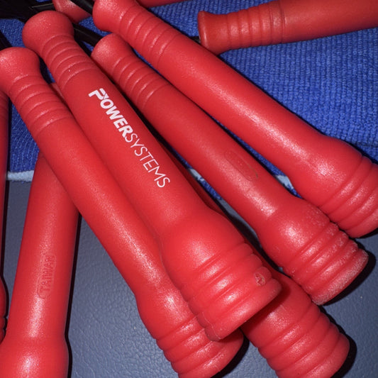 6 Power Systems red and black jump rope handles showing textured grips and brand logo on close-up view