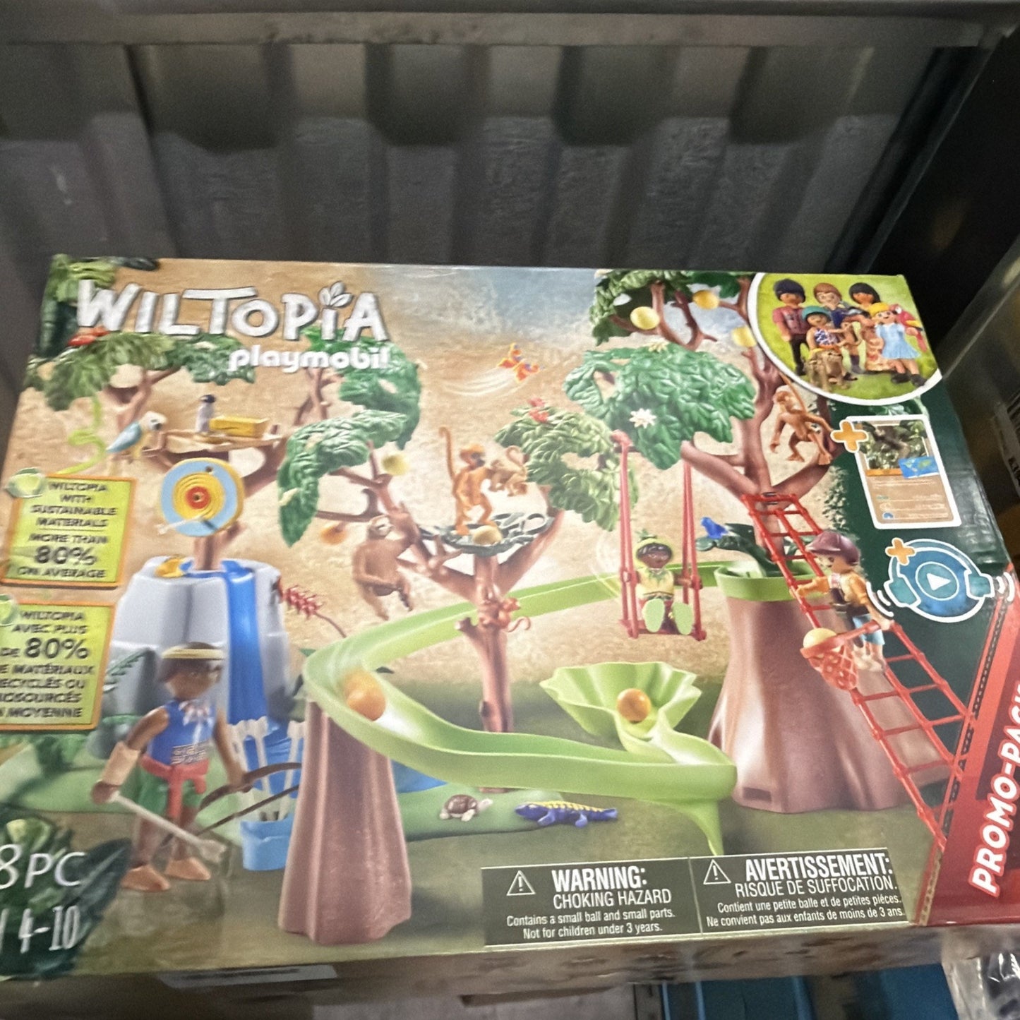 Playmobil Wiltopia playset featuring a treehouse scene with multiple monkey figures, a slide, a swing, and various accessories designed for children aged 4 to 10.