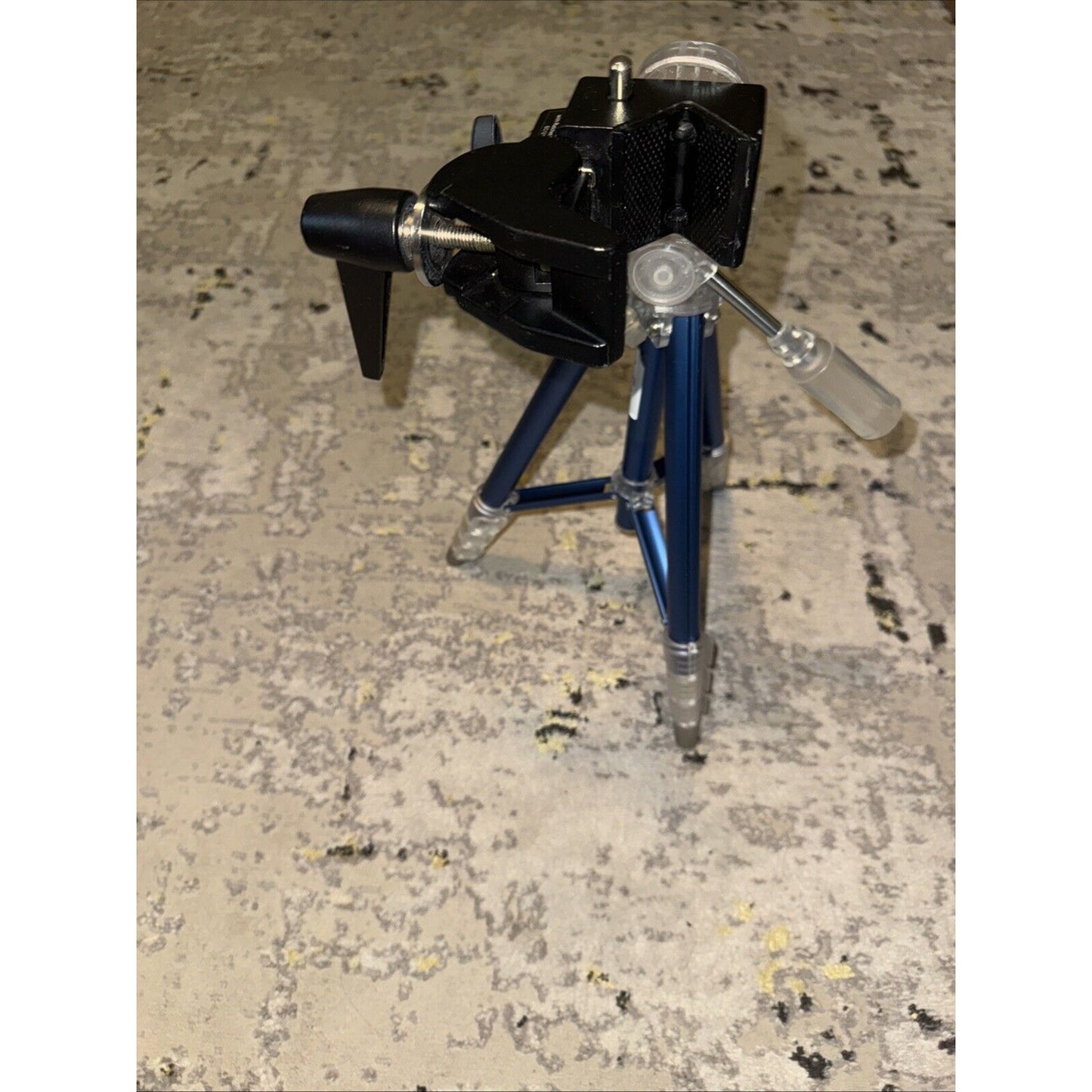 Digipower compact photo and video tripod with adjustable legs and mount for GoPro and cameras on textured floor