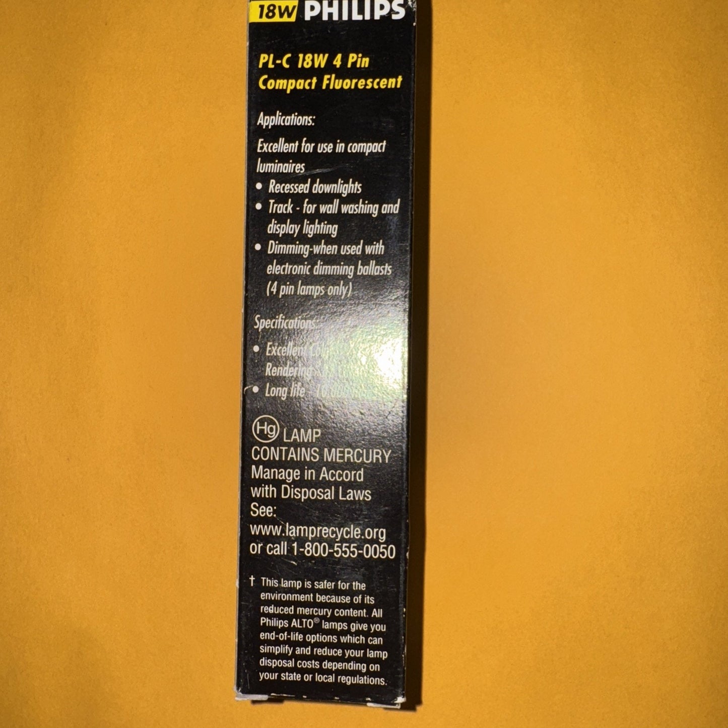 Philips PL-C 18W 4-pin compact fluorescent light bulb packaging with product details and applications text
