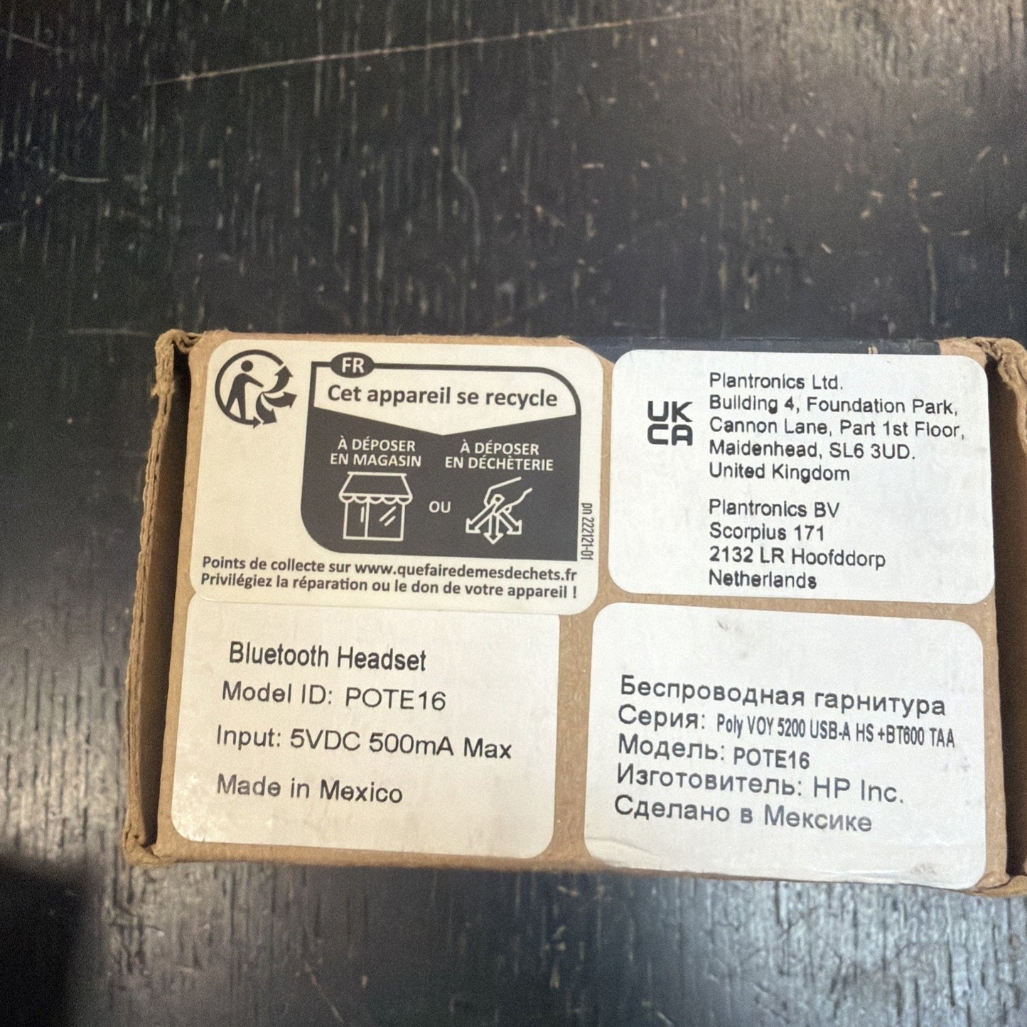 Recycling instructions and multilingual product information labels on a cardboard box for a Bluetooth headset, including manufacturer and model details.
