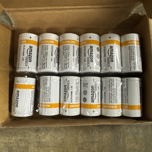Box of 12 Amazon Basics Alkaline C batteries arranged in two rows with white and orange labeling visible
