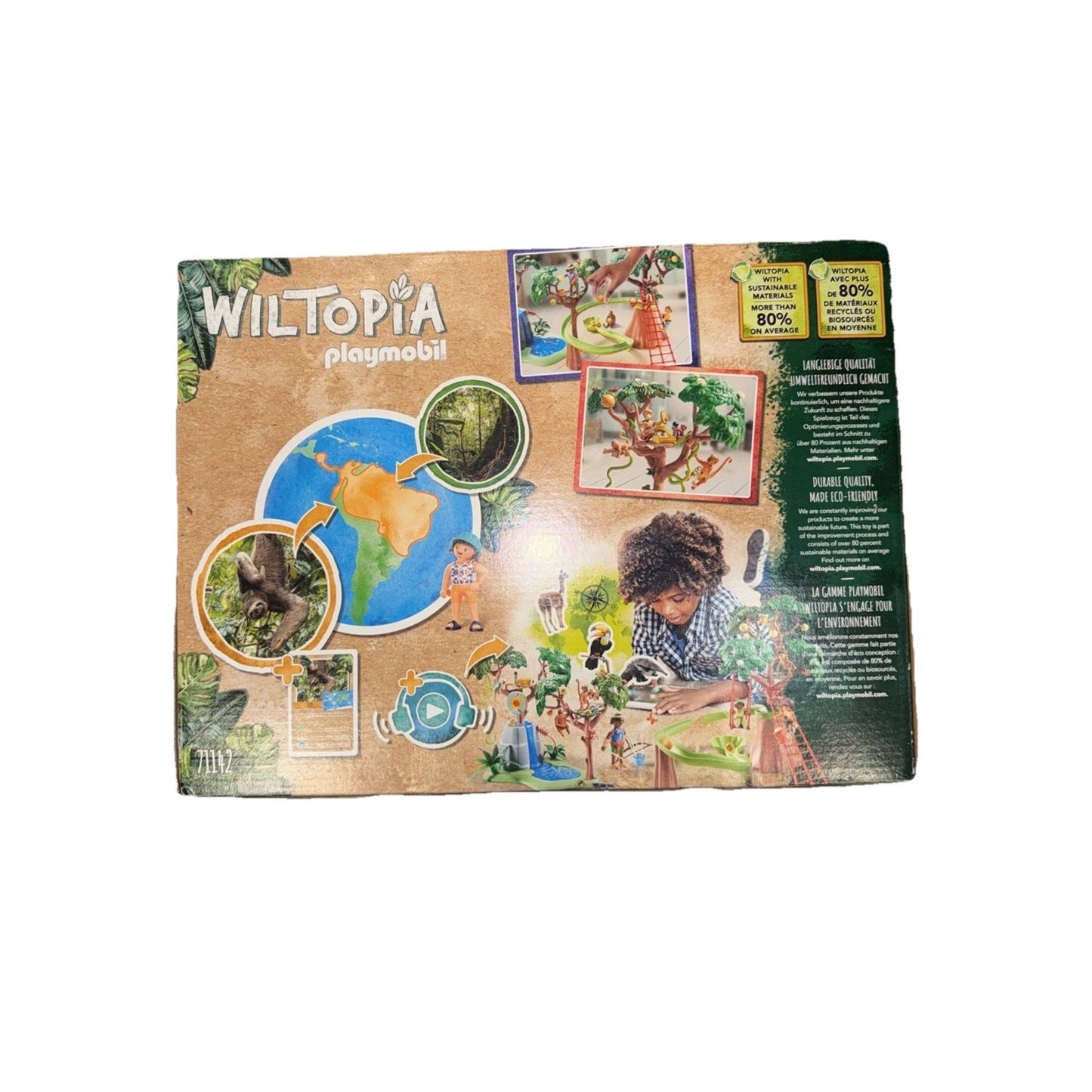 Rectangular game box with WILTOPIA and Playmobil branding featuring images of animal figures, a globe, and a child playing with nature-themed toys on a light brown background.