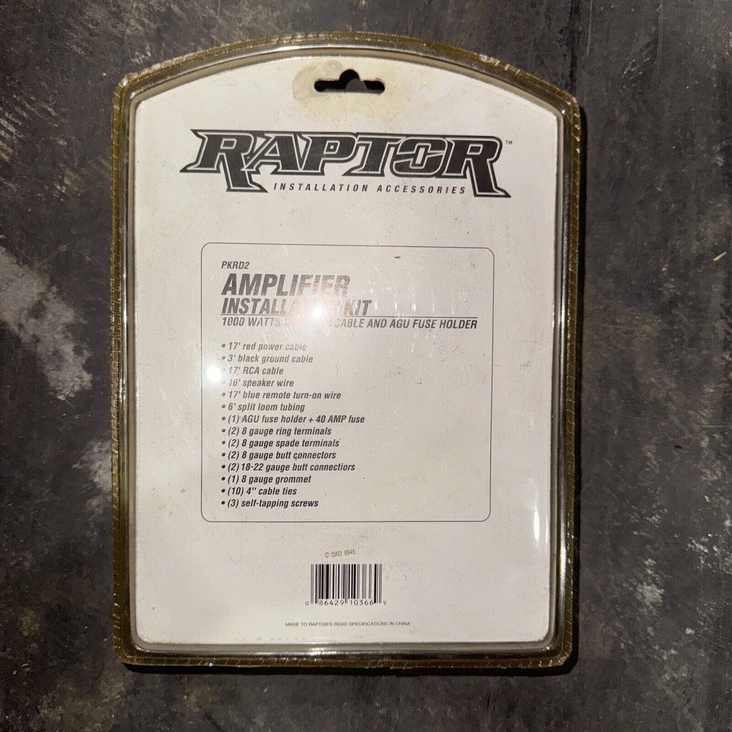 Raptor amplifier installation kit packaging showing included cables, terminals, fuses, and screws for audio setup