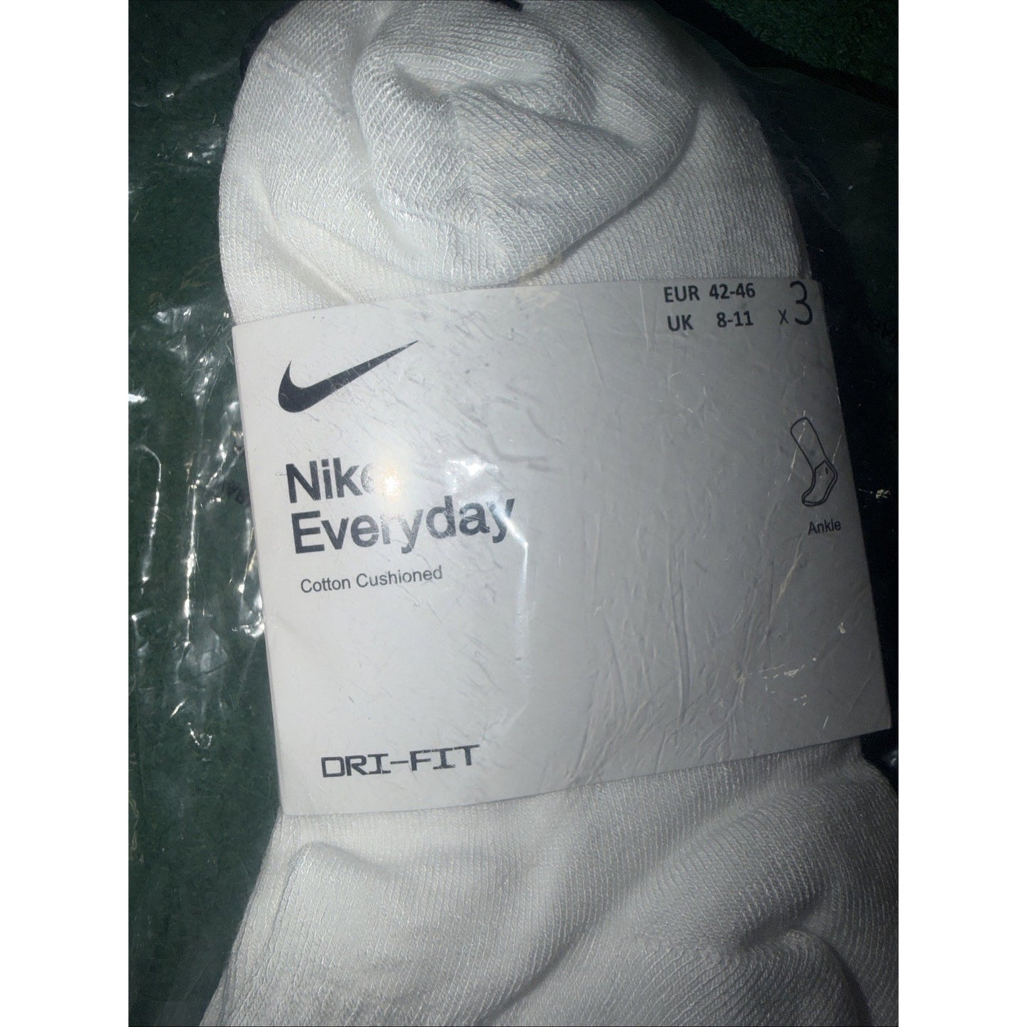 White Nike Everyday cotton cushioned socks packaged in a plastic wrap with a white label showing size EUR 42-46, UK 8-11, and Dri-FIT technology branding.