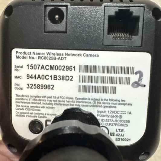 Back view of ADT Wireless Network Camera Model RC8025B-ADT showing serial number, MAC, and power input details