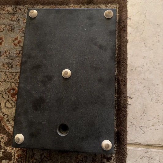 8" x 12" x 2" granite surface plate with alignment pins and hole on carpeted floor background
