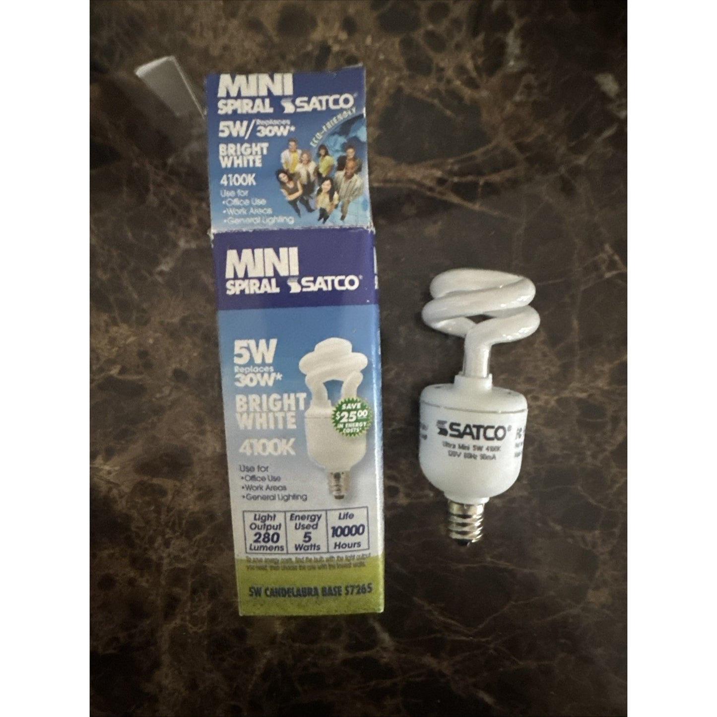 Satco 5W mini spiral fluorescent bulb with E12 candelabra base and 4100K bright white light next to packaging box