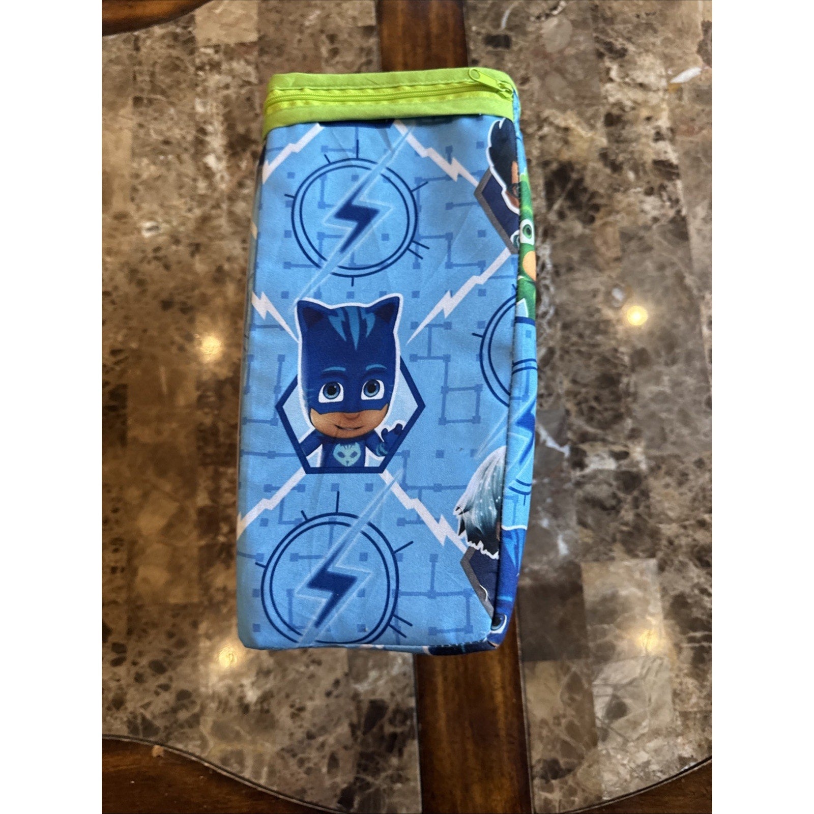 Folded PJ Masks toddler bed bedding set with Catboy character and lightning bolt design on blue background