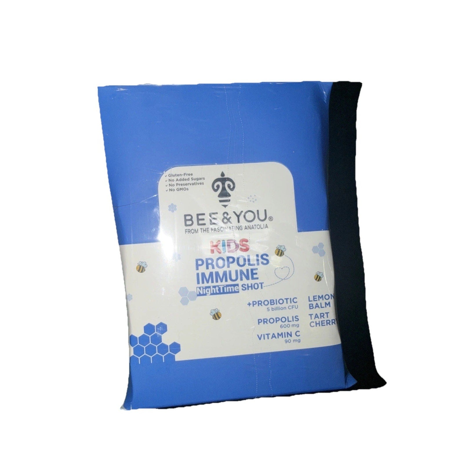 Blue and white packet of Bee & You Kids Propolis Immune Nighttime Shot with lemon balm, tart cherry, probiotics, propolis, and vitamin C, featuring bee and honeycomb illustrations.