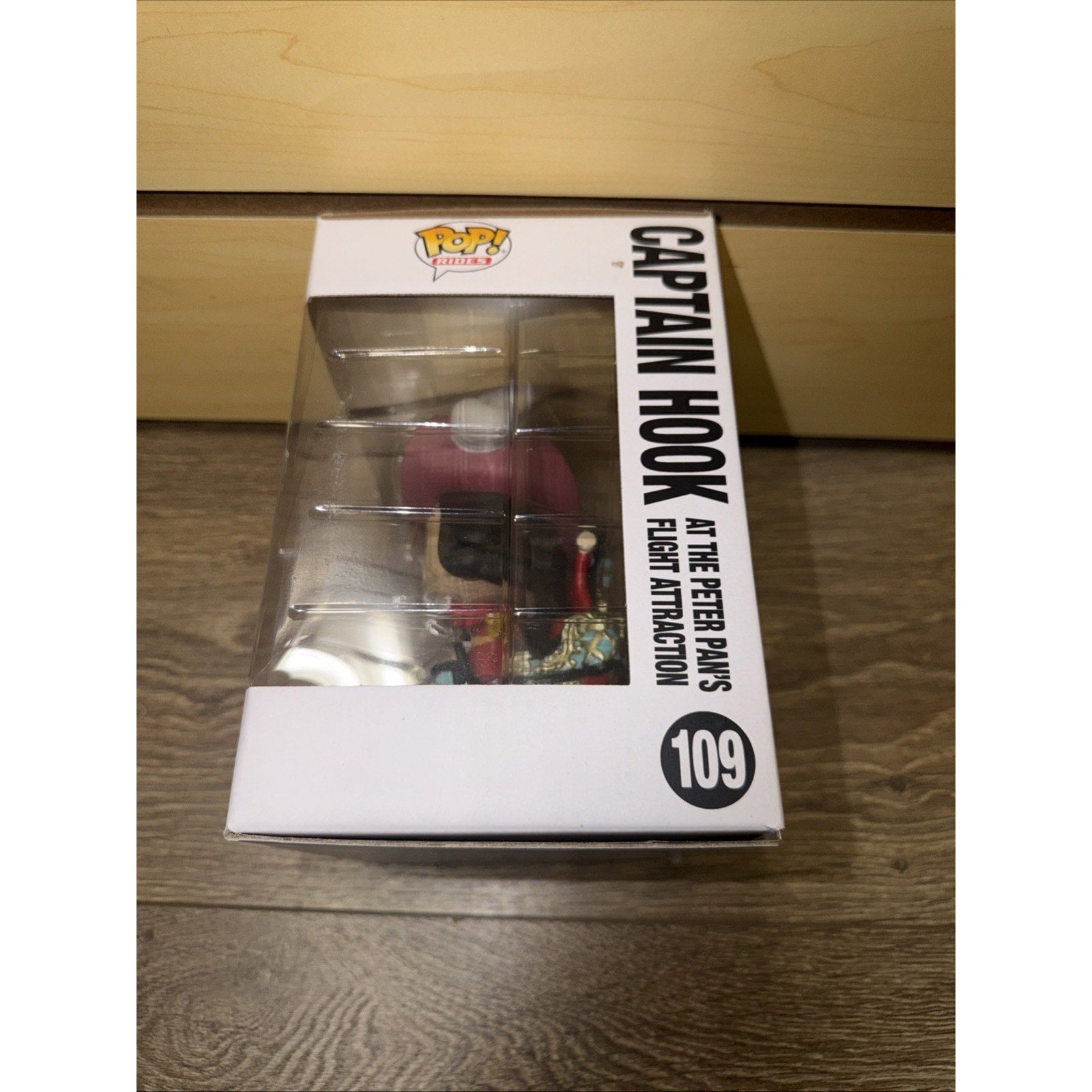 Funko Pop! vinyl figure of Captain Hook from the Peter Pan's Flight attraction, displayed in a white collectible box with clear window and bold black text.