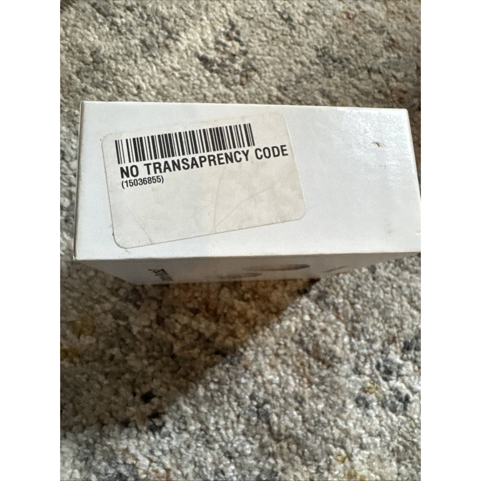 White Samsung Galaxy Buds2 box showing barcode sticker with text No Transparency Code on carpet background