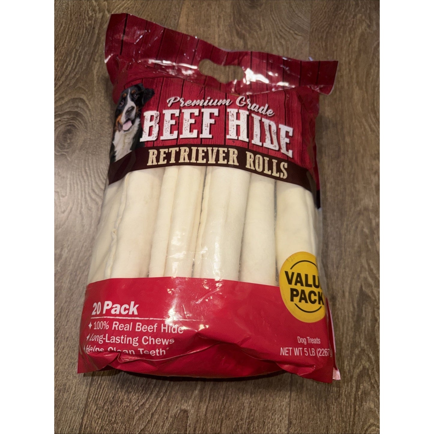 Plastic resealable bag containing 20 white beef hide retriever roll dog chews labeled as premium grade and value pack, displayed on a wooden surface.