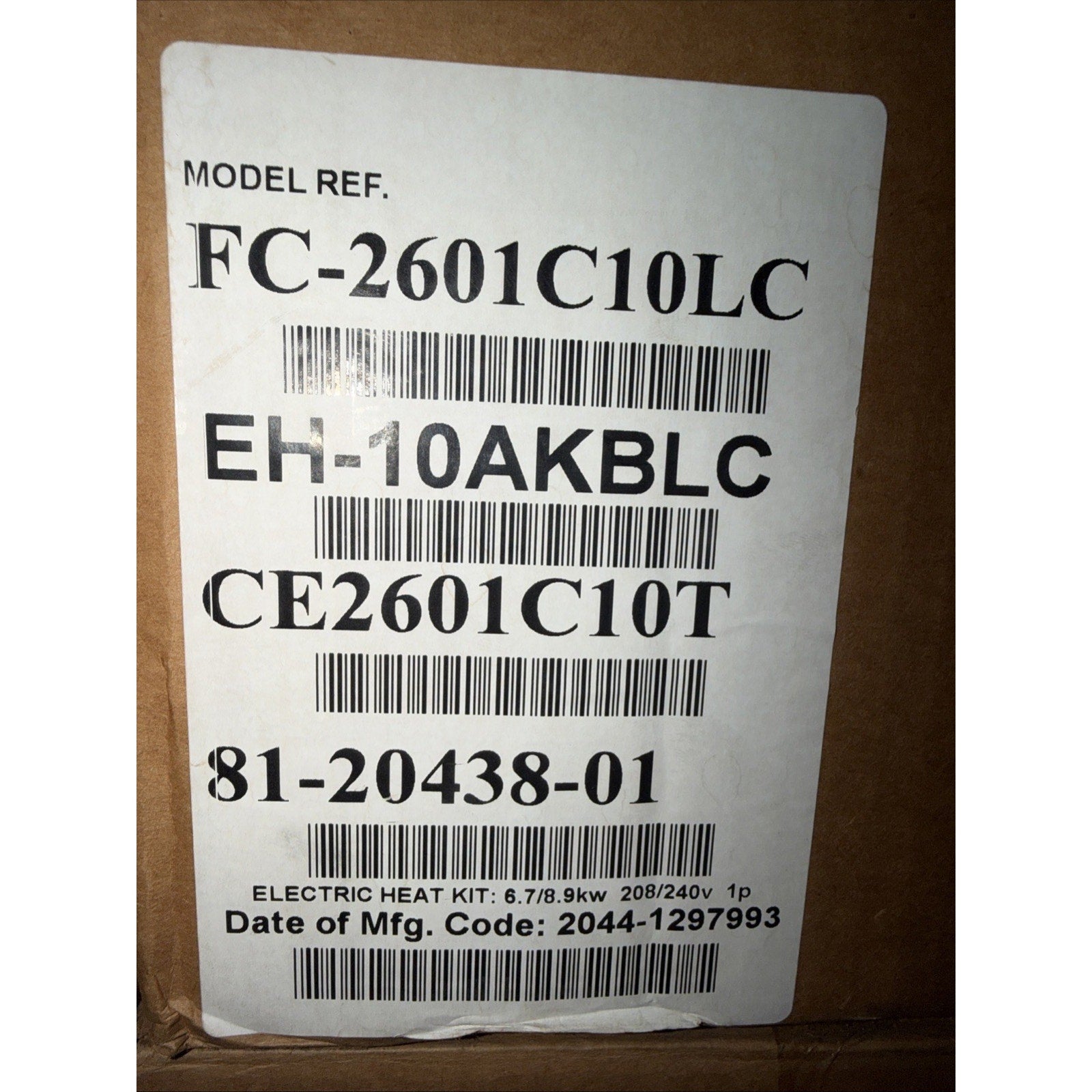 White label on a brown cardboard box displaying model reference codes, barcodes, and electric heat kit specifications including power rating and voltage information.