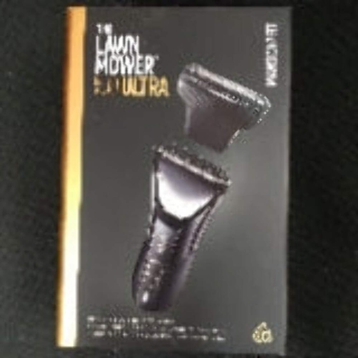 Black and gray packaging featuring The Lawn Mower 3.0 Ultra electric shaver with close-up images of the shaver and detachable head against a dark background.