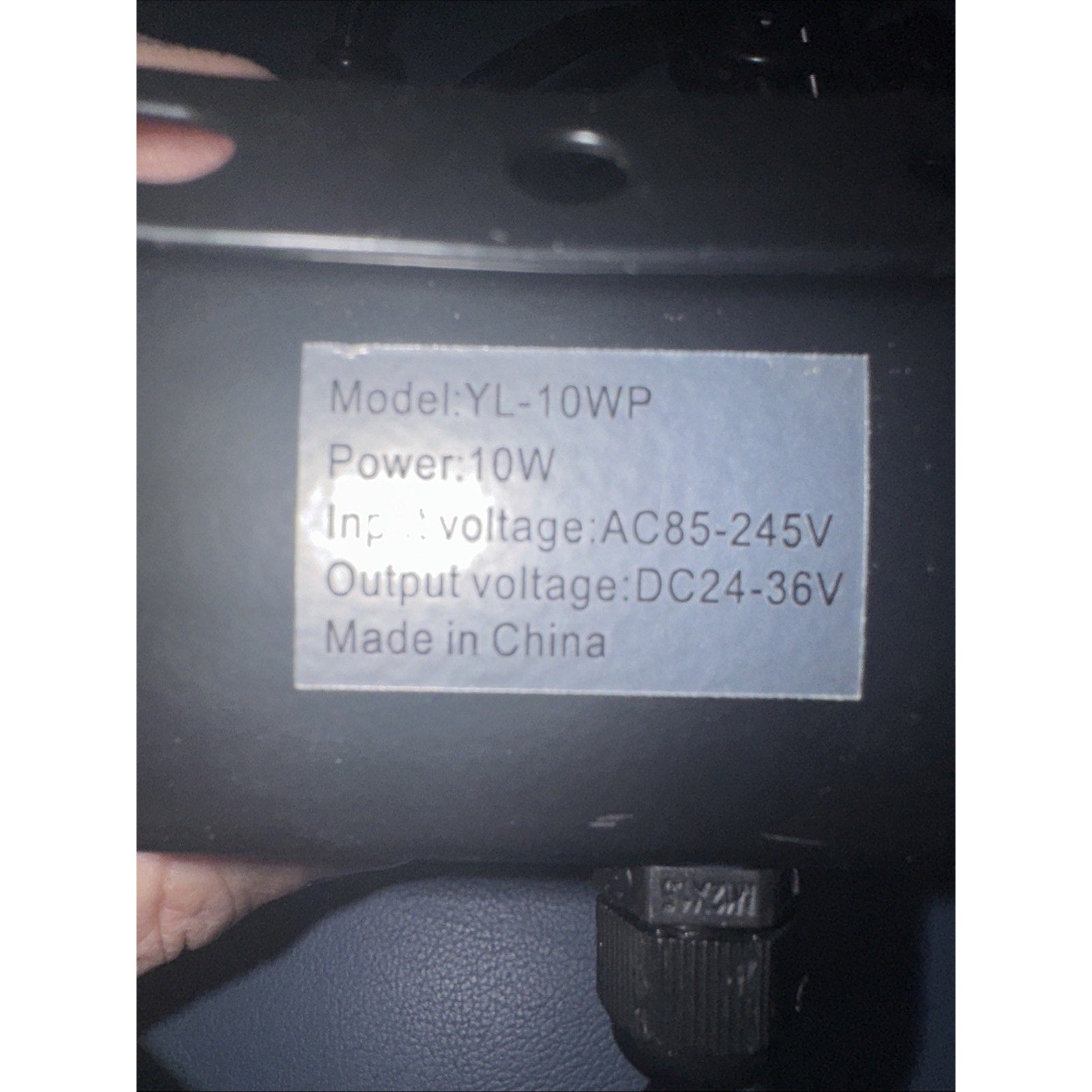 Label on black YL-10WP LED floodlight showing power 10W input voltage AC85-245V output DC24-36V made in China