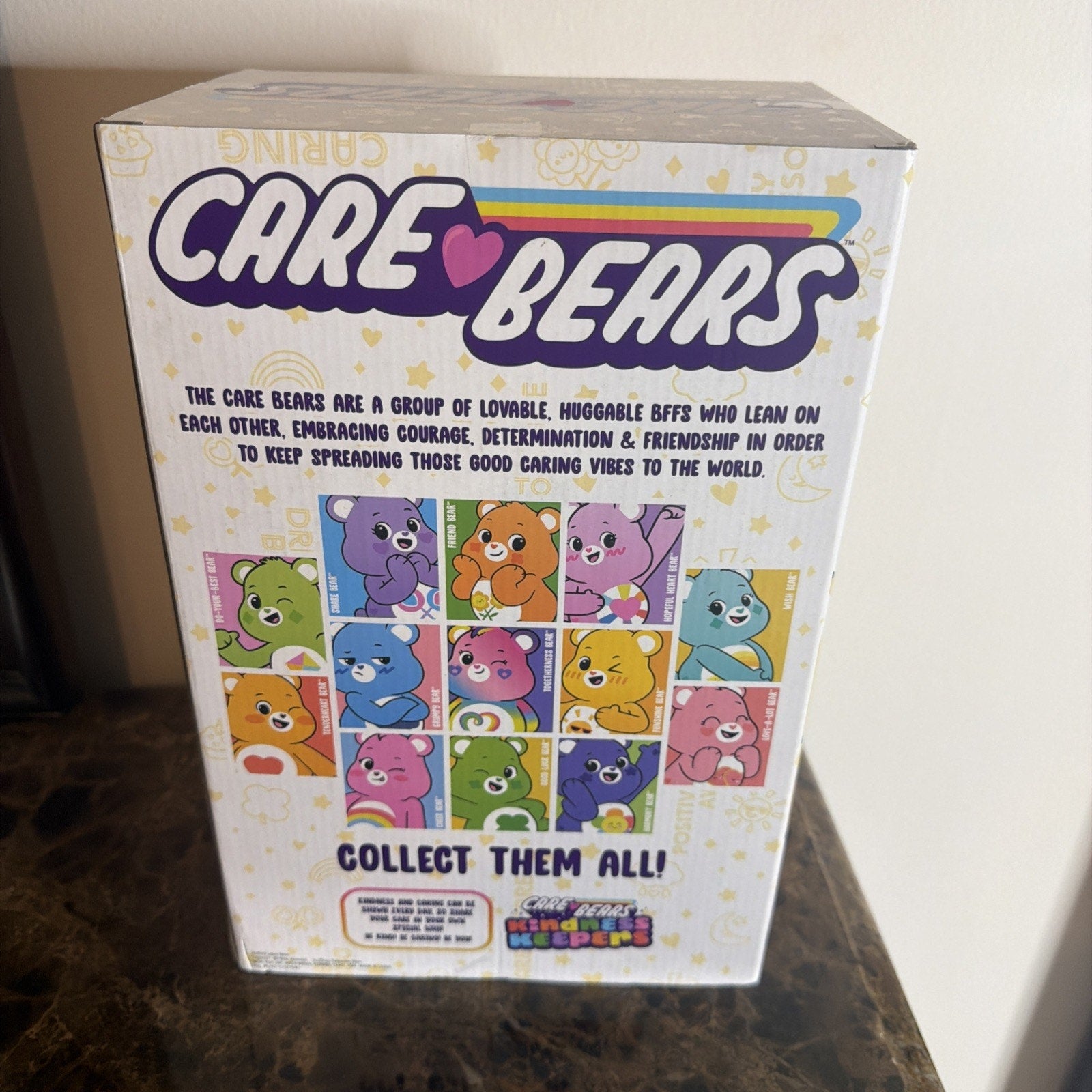 Back of a Care Bears collectible box featuring colorful illustrations of various Care Bears characters with a message about courage, determination, and friendship.