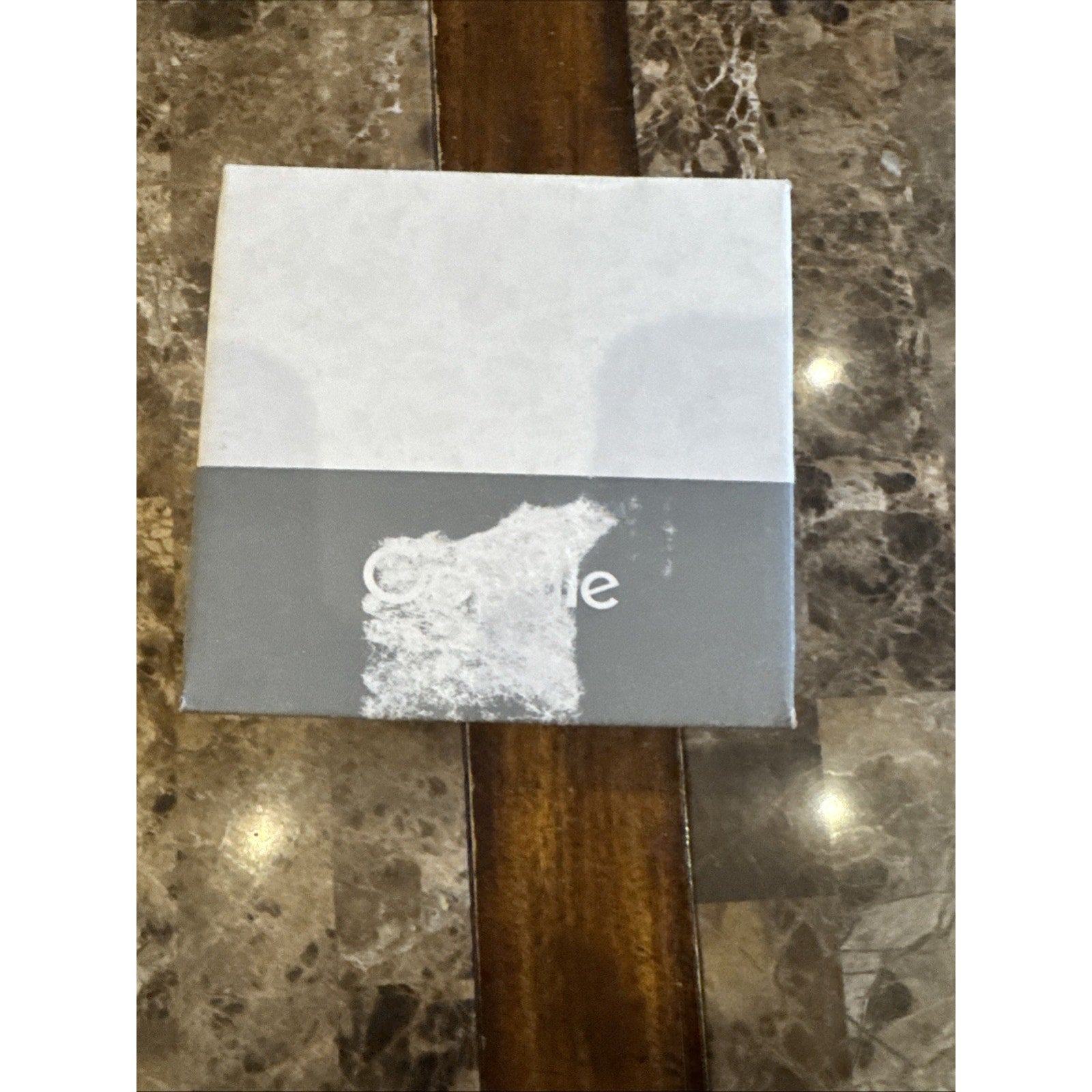 Google Nest WiFi 2nd Generation Access Point box with white and gray design placed on marble table surface