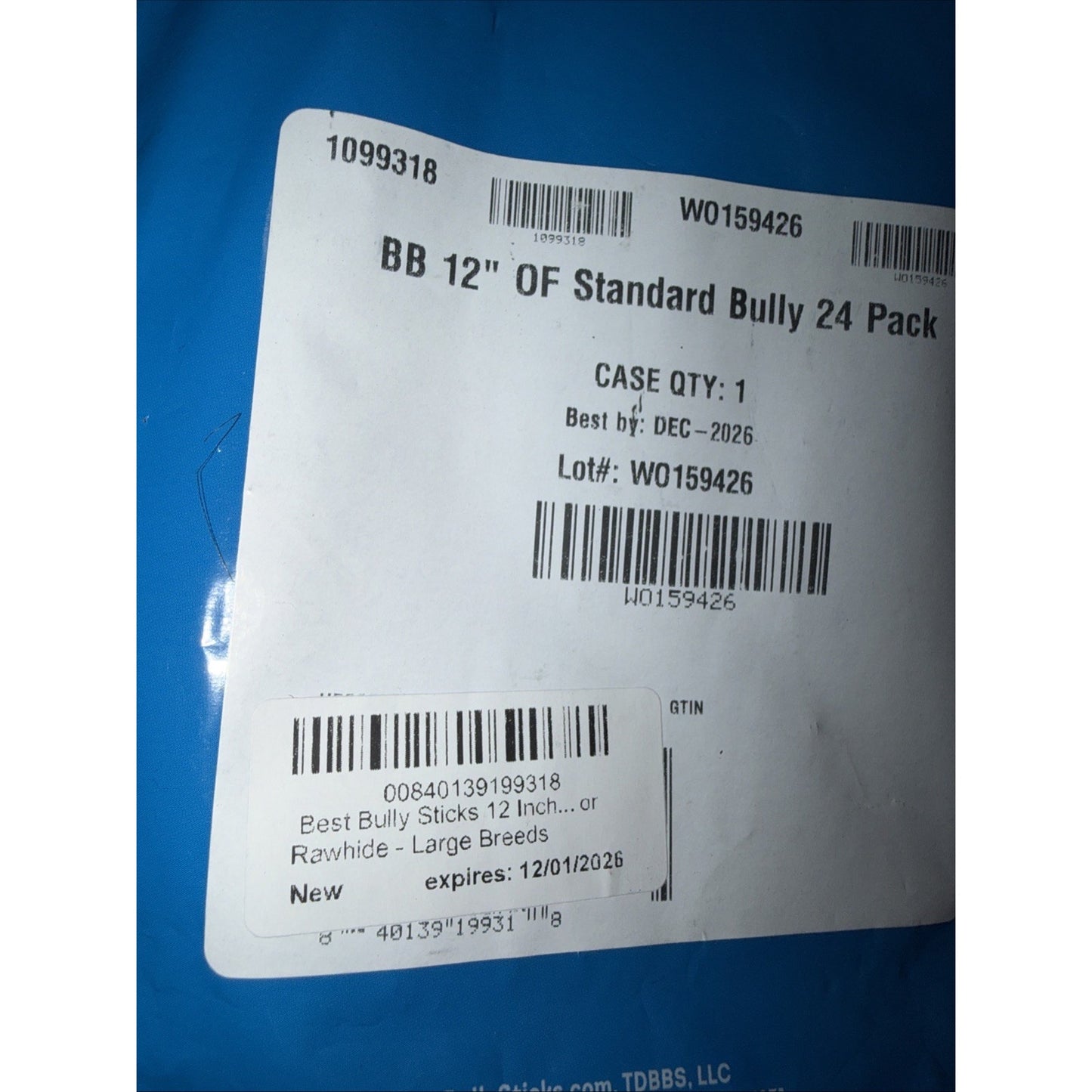 White product label on blue packaging displaying barcodes, product details for a 24-pack of 12-inch bully sticks, best before date of December 2026, and lot number.