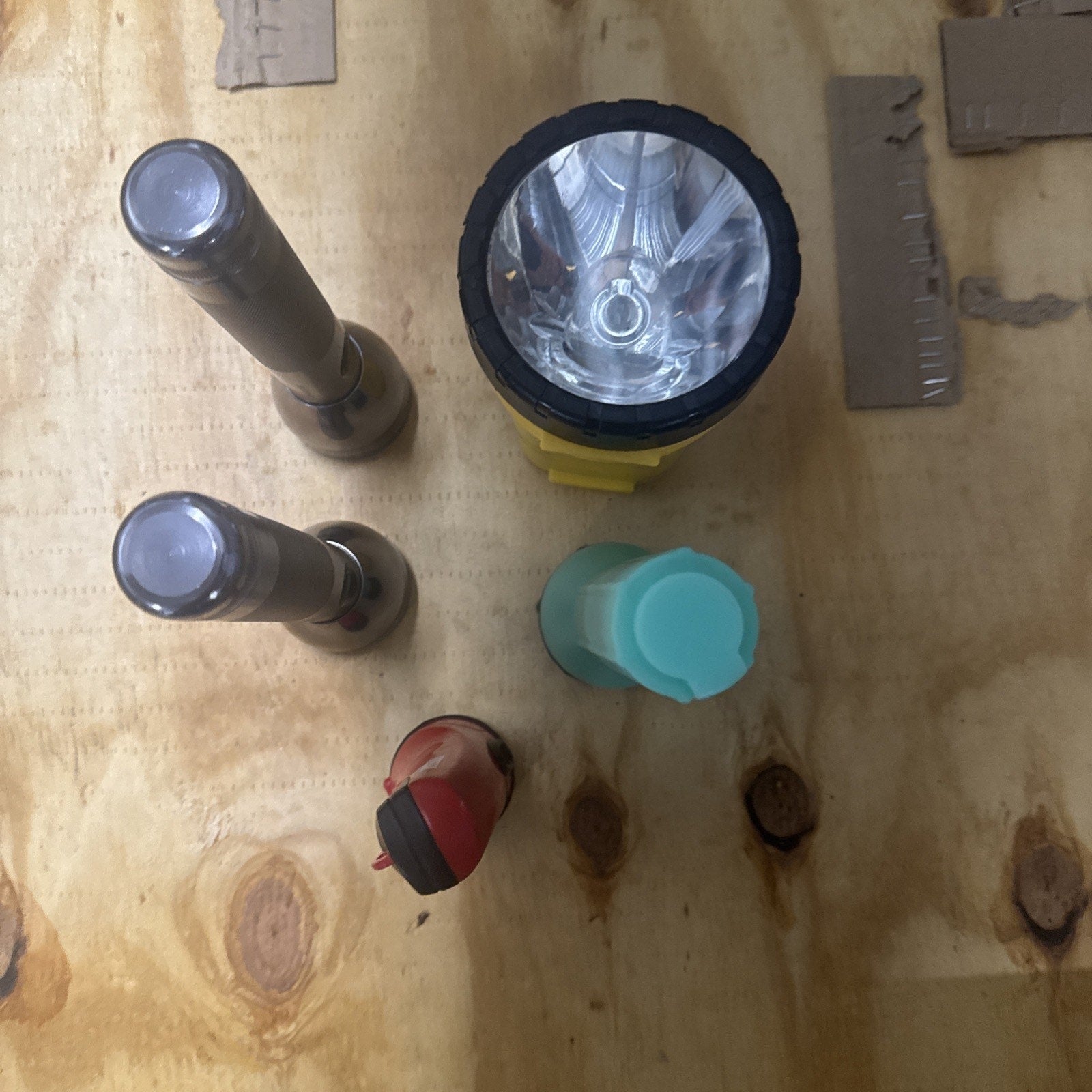 Lot of 5 vintage working flashlights including Maglite style and Eveready models shown on wooden surface