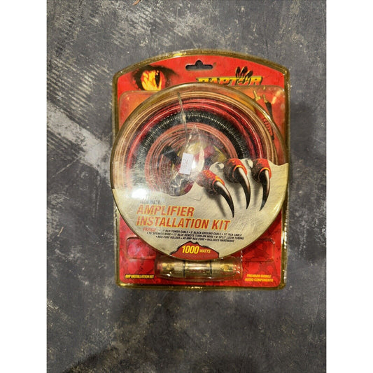 Raptor amplifier installation kit with cables and fuse holder in red and black packaging showing claw design and 1000 watt power rating