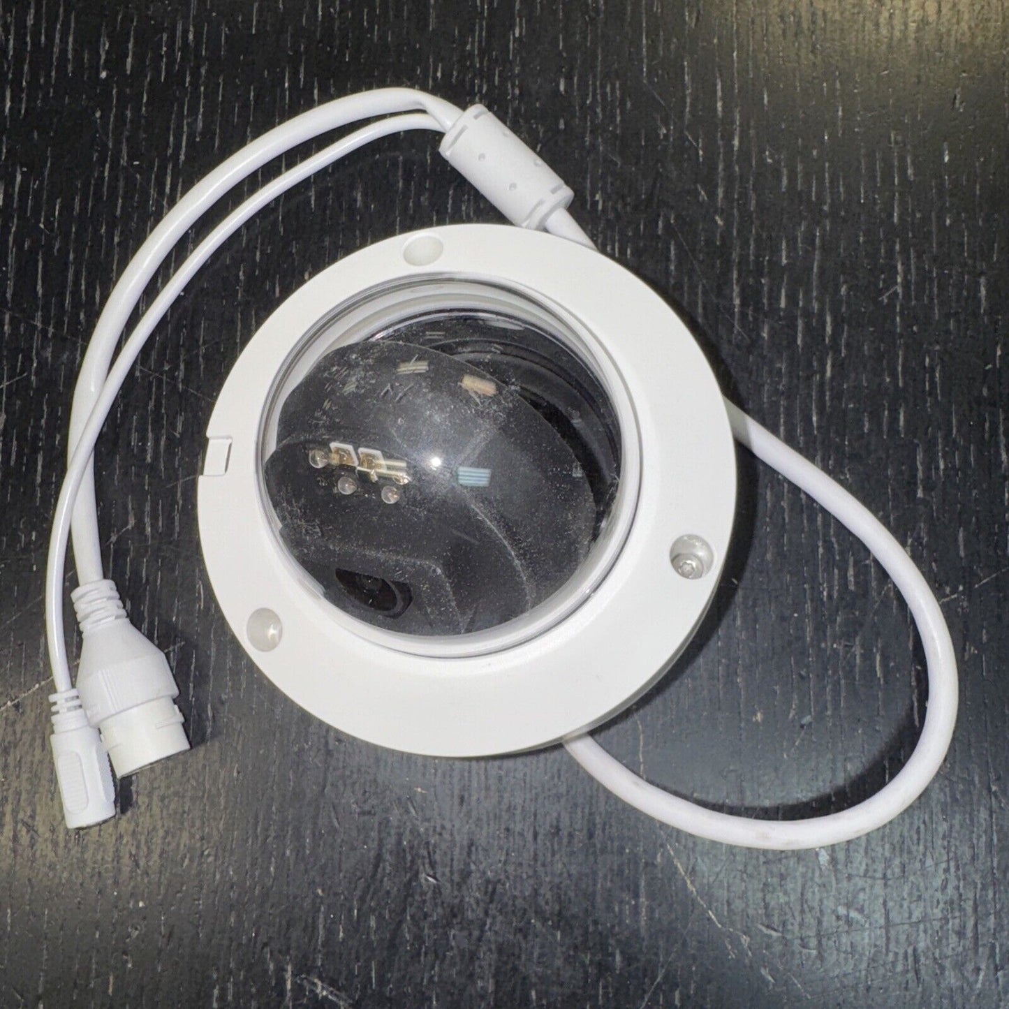 Alarm.com ADC-VC826 POE dome security camera with white housing and dual cables for outdoor and indoor surveillance