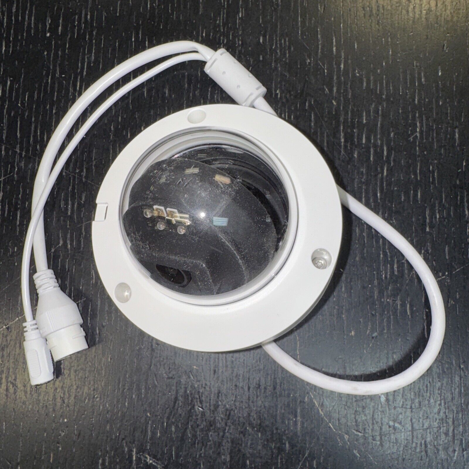 Alarm.com ADC-VC826 POE dome security camera with white housing and dual cables for outdoor and indoor surveillance