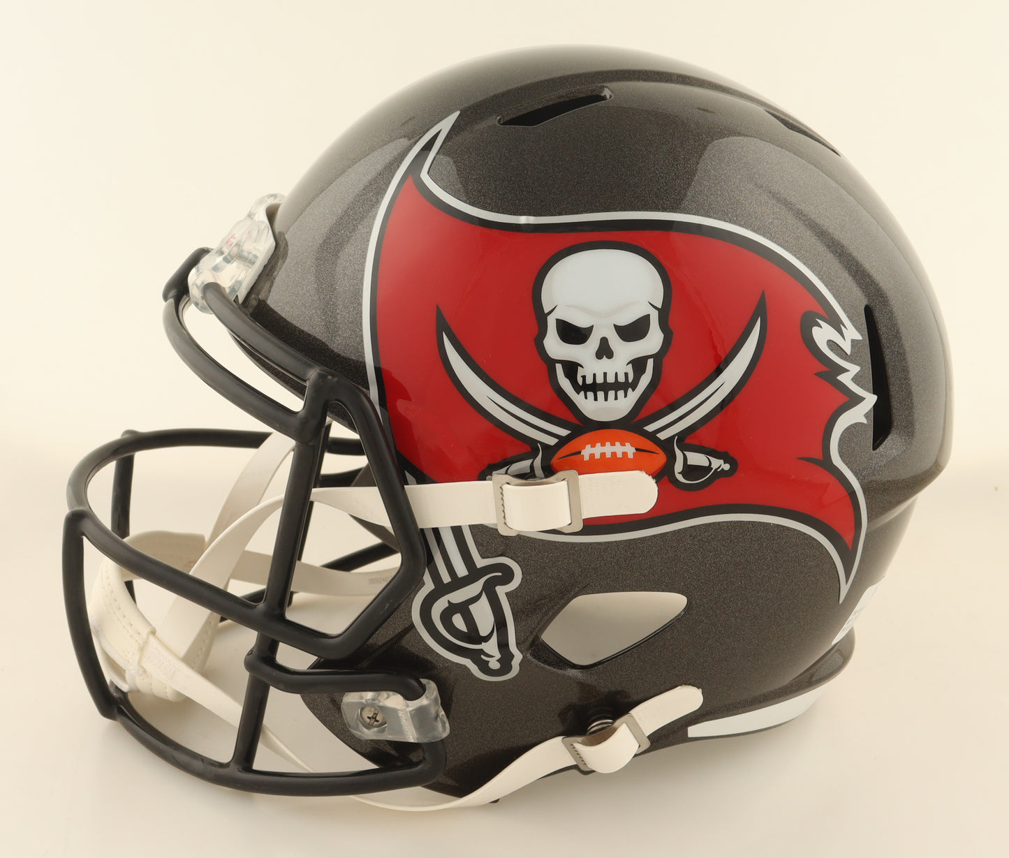 Tampa Bay Buccaneers full-size speed helmet showing team logo on dark gray shell with black face mask and white chin strap