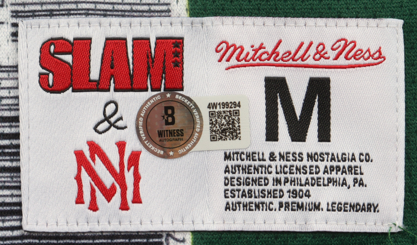 Mitchell & Ness authentic jersey label with size M, Beckett Witness hologram, and Slam and NY logos stitched on white fabric