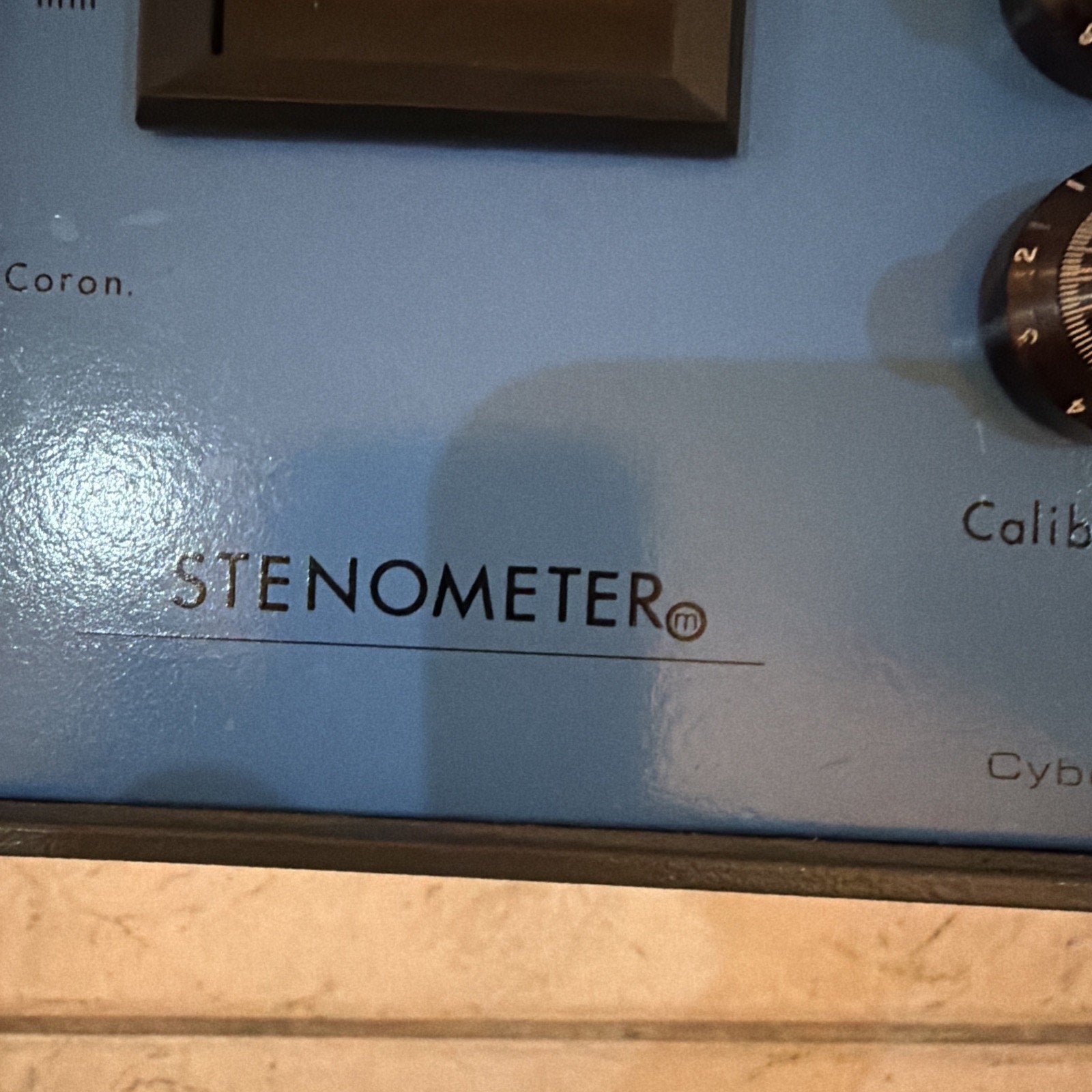 Close-up of Cybermedics Stenometer cardiology lab instrument control panel with calibration dial and blue surface