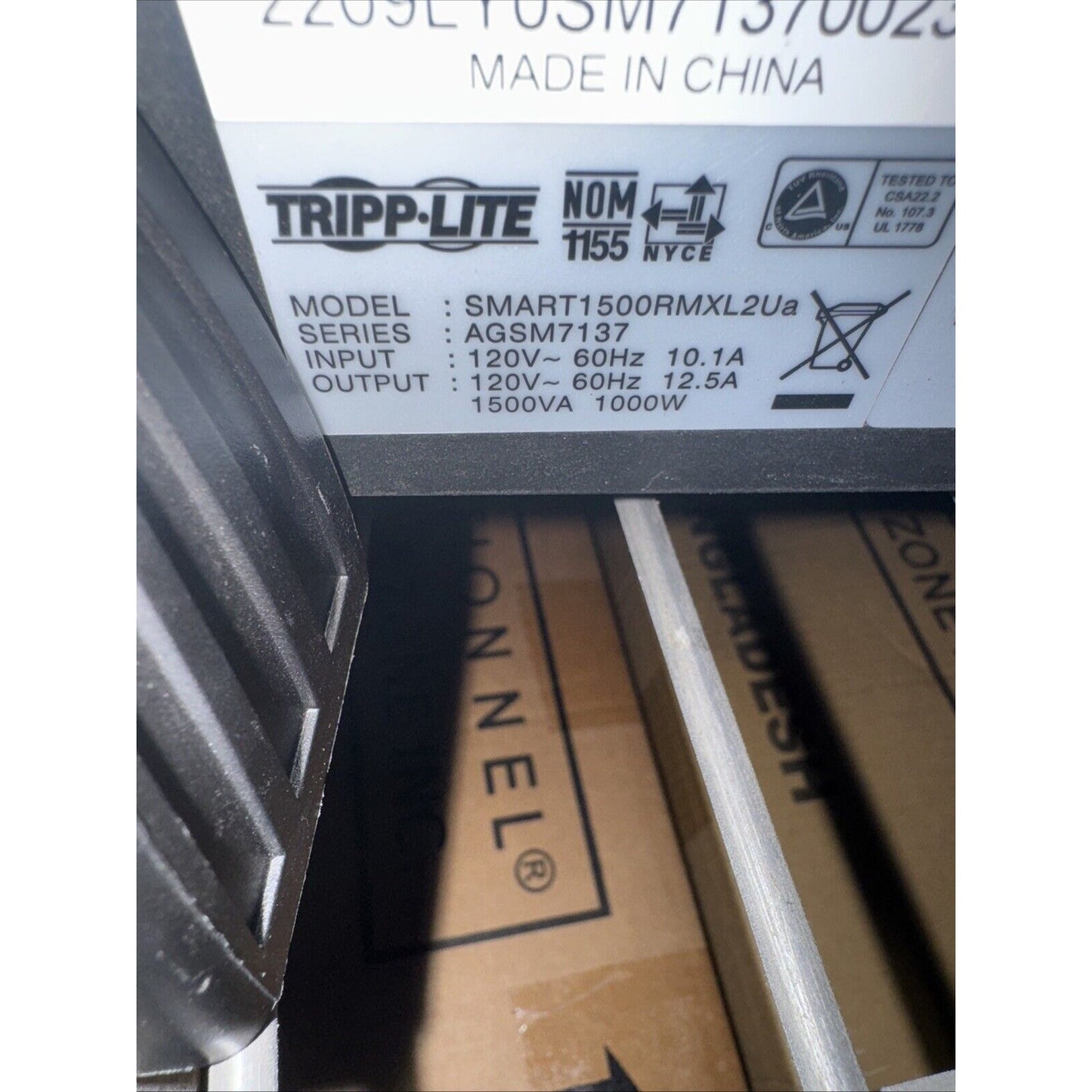 Close-up of Tripp Lite SMART1500RMXL2Ua UPS label showing input 120V 60Hz 10.1A and output 1500VA 1000W specifications