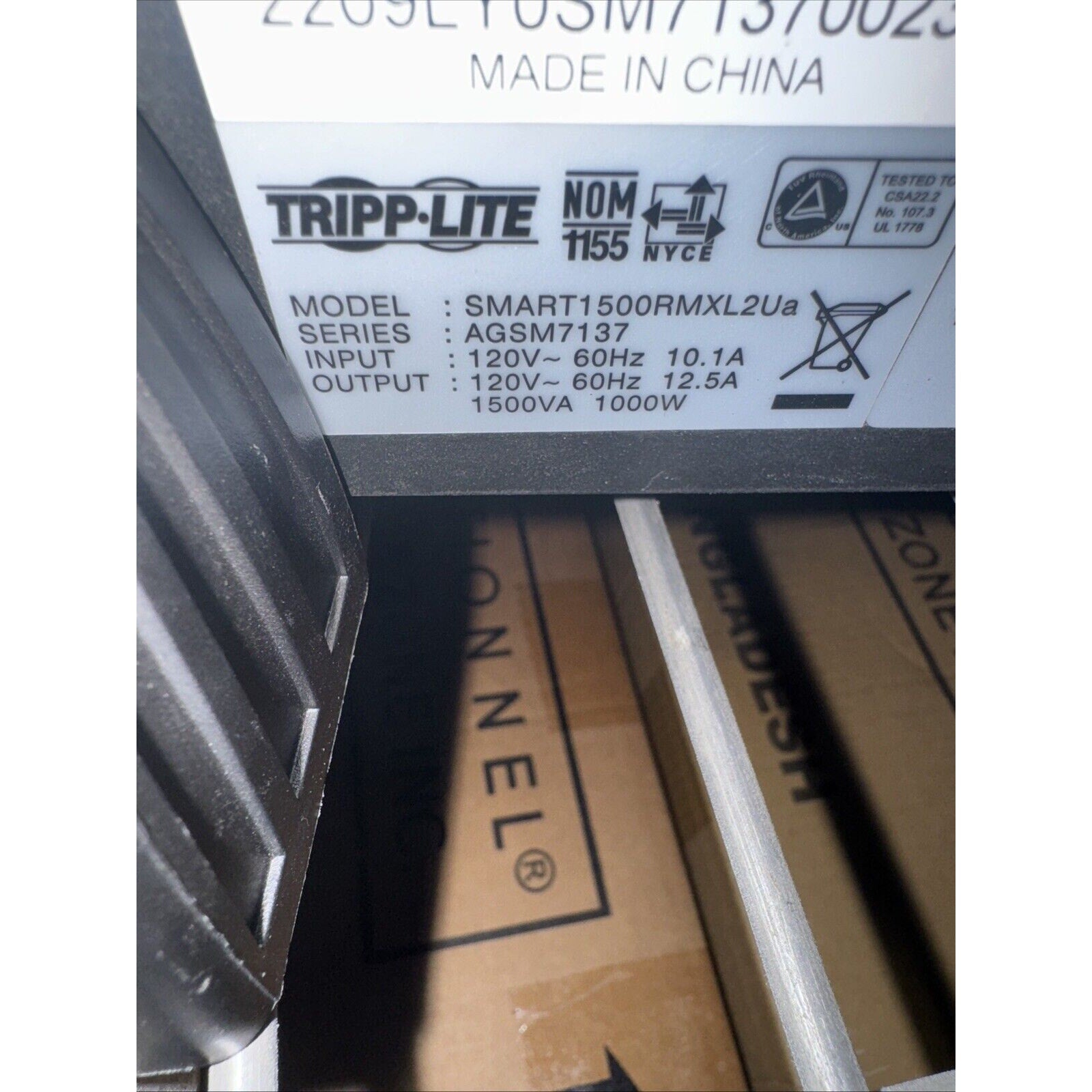 Close-up of Tripp Lite SMART1500RMXL2Ua UPS label showing input 120V 60Hz 10.1A and output 1500VA 1000W specifications