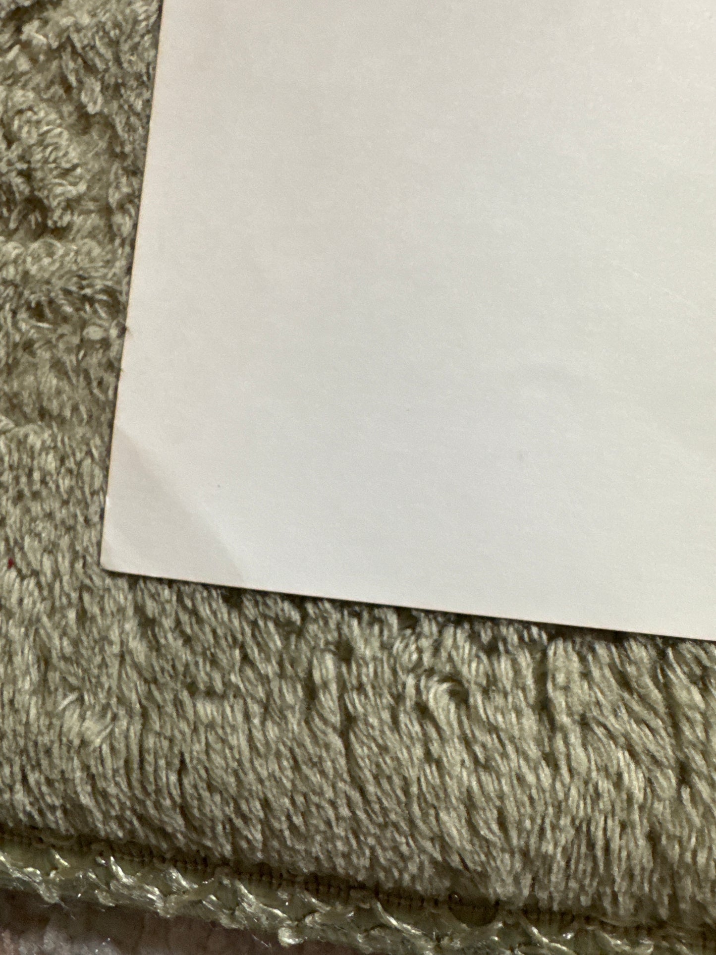 Partial close-up of signed 20x24 Rangers hockey team photo showing fabric texture and edge of the poster