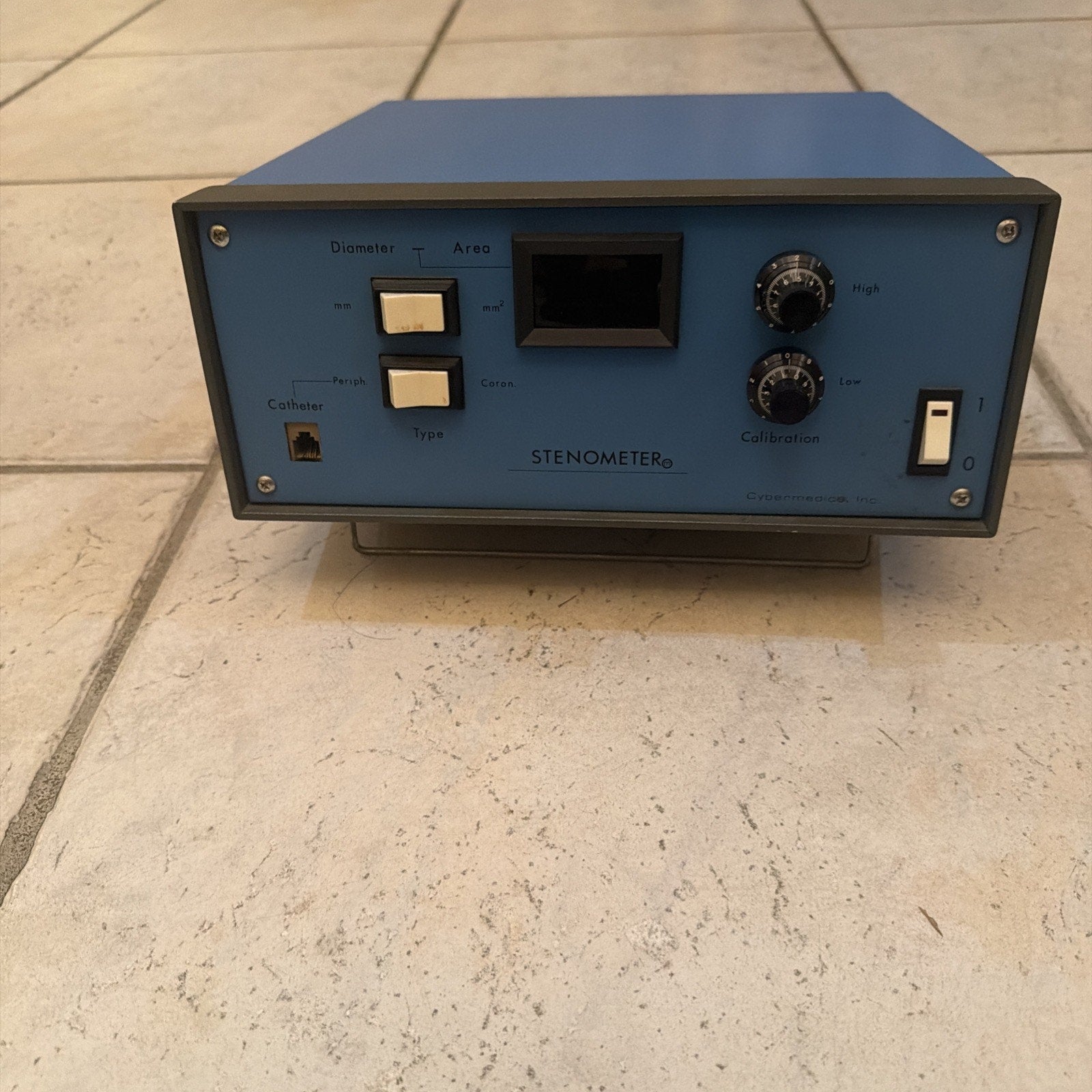 Cybermedics Stenometer cardiology lab instrument with control knobs, buttons, and a small display on blue panel casing