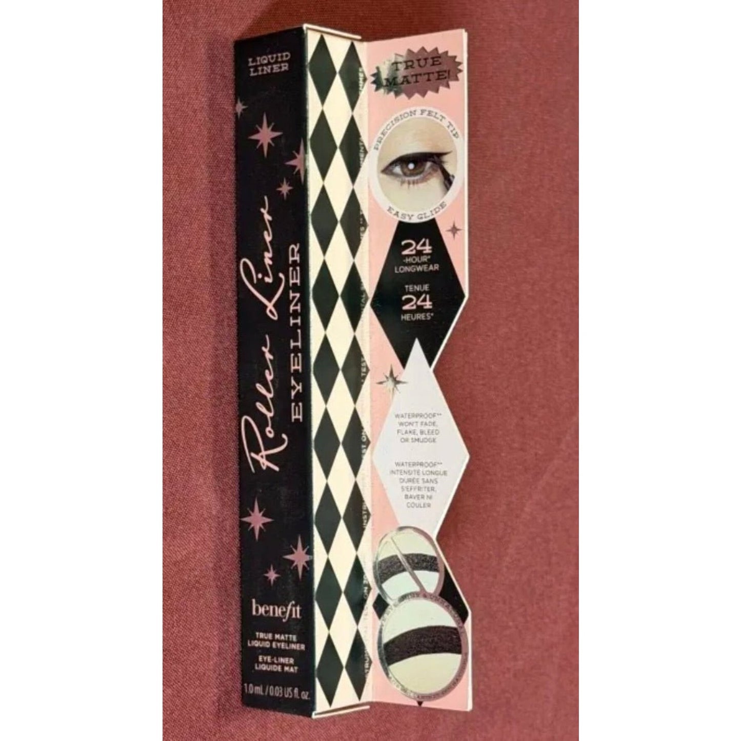 Packaging of a Benefit Roller Liner liquid eyeliner box featuring vintage-inspired design with black and white diamond patterns, pink accents, and eye illustration, highlighting 24-hour waterproof wear and smudge-proof formula.