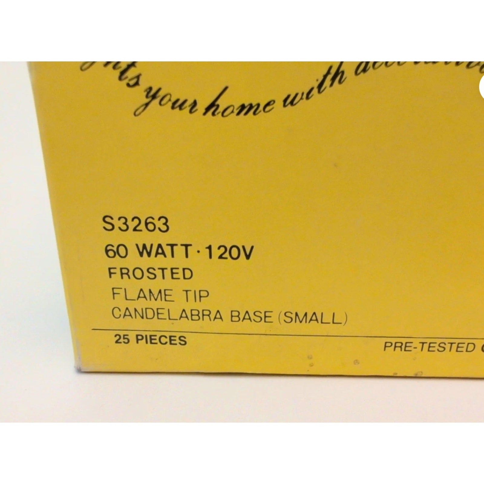 Yellow product packaging corner showing printed details for 60 watt, 120 volt frosted flame tip light bulbs with small candelabra base, containing 25 pieces.