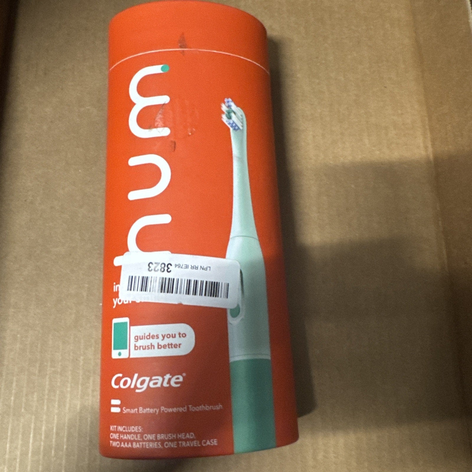 Colgate Hum smart battery powered toothbrush box in orange with toothbrush image and product details visible