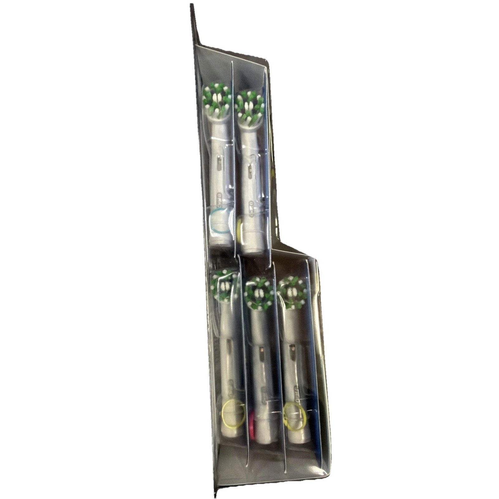 Top view of five electric toothbrush replacement heads with green and white bristles, each individually separated in clear plastic compartments within a rectangular package.