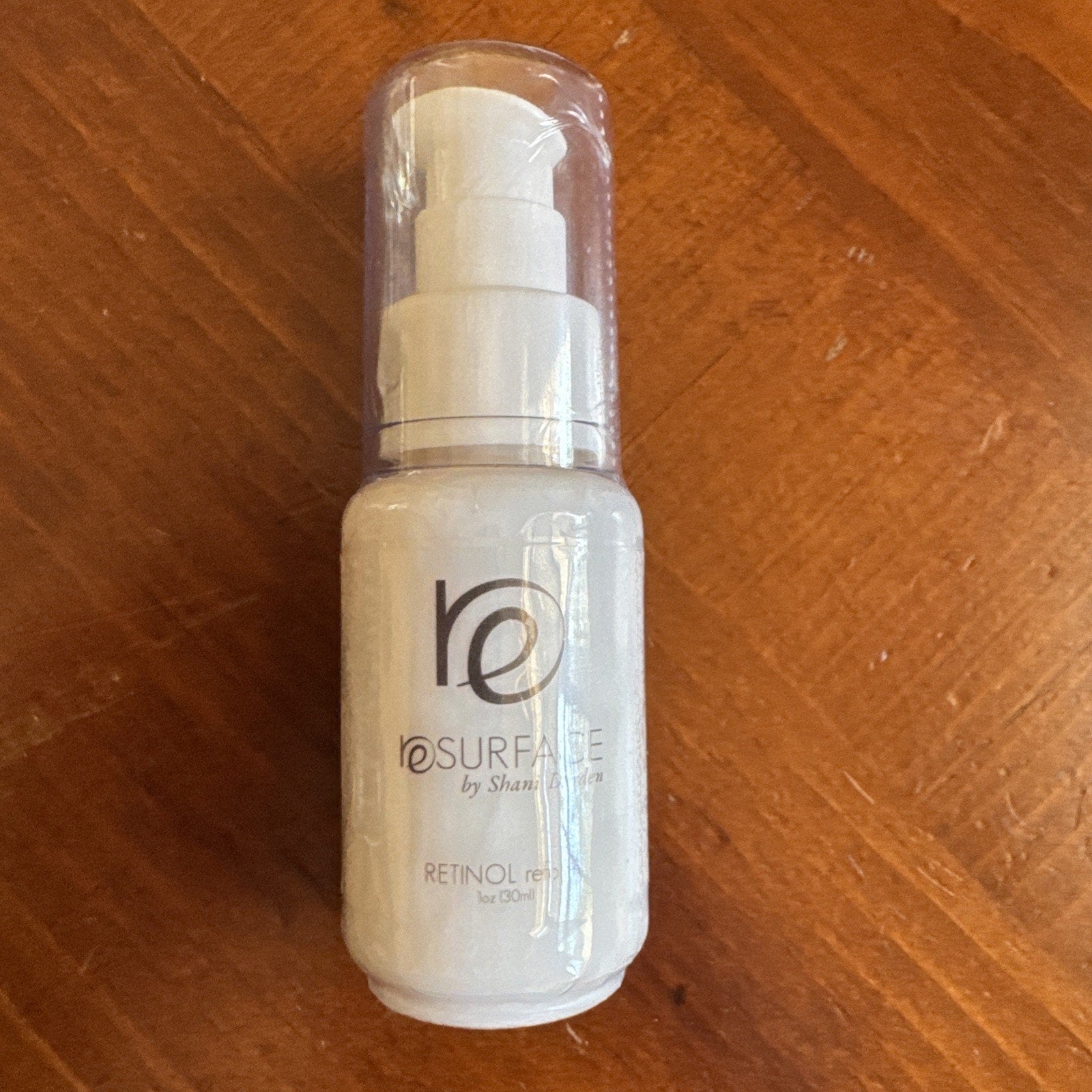 NEW SEALED Resurface by Shani Darden Retinol Reform Peel 1 oz bottle with pump dispenser on wooden surface