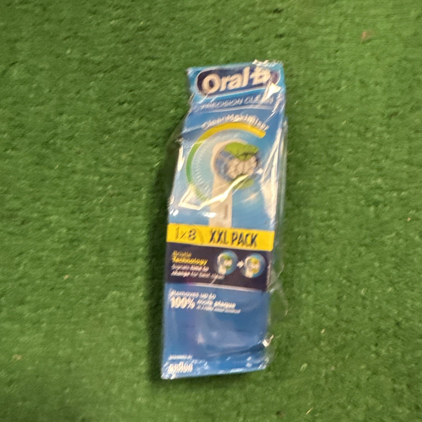 Oral B Precision Clean replacement electric toothbrush heads pack of 8 in blue and white packaging on green surface
