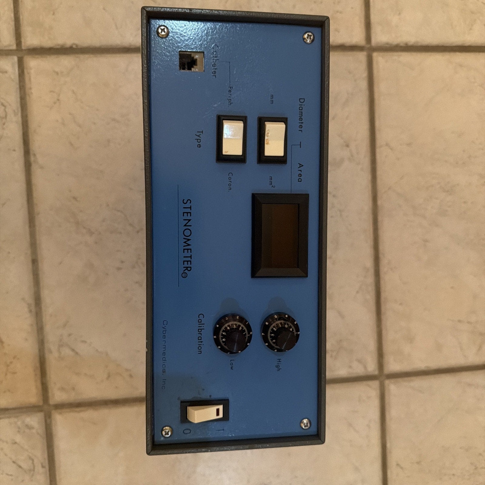 Cybermedics Stenometer cardiology lab instrument control panel with switches, dials, and digital display on blue faceplate