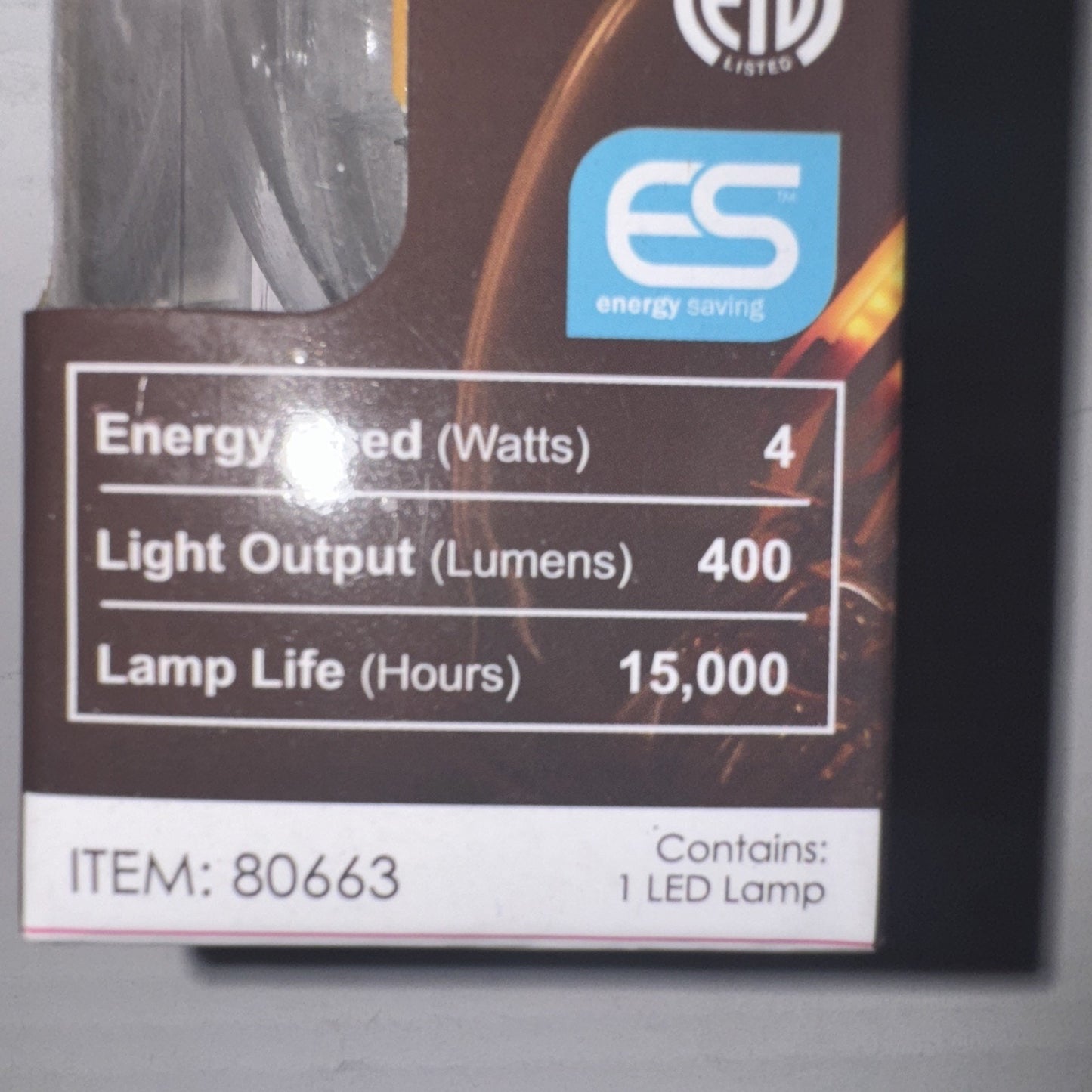 Close-up of Sunlite LED filament bulb box showing 4W energy use, 400 lumens output, and 15,000 hours lamp life details