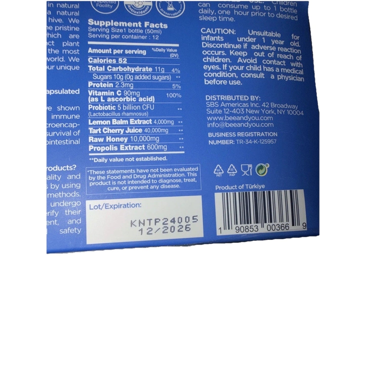 Blue product label showing supplement facts for a propolis immune nighttime shot with ingredients including vitamin C, probiotics, lemon balm extract, tart cherry juice, raw honey, and propolis extract, along with caution and distribution information, barcode, and expiration date.