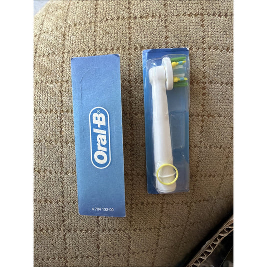 Oral-B replacement electric toothbrush head in clear plastic packaging next to blue Oral-B branded box