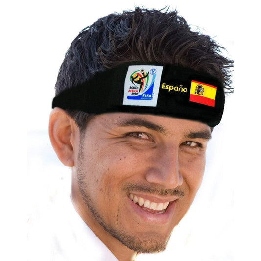 Man smiling and wearing a black headband featuring the 2010 FIFA World Cup South Africa logo, the Spanish flag, and "España" text on a white background.